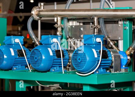 Factory equipment, electric motors in blue casing are in the line of the production line to create powerful airflow. Stock Photo