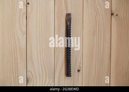 Iron chisel on a light wooden background. Work concept. Stock Photo