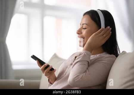 Excited African American music fan wearing headphones Stock Photo