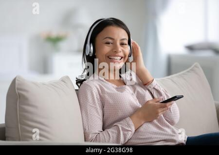 Happy African American woman in wireless headphones Stock Photo