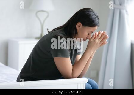 Depressed tired mixed raced woman feeling sorrow Stock Photo