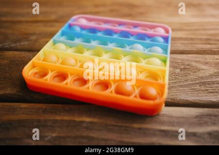 Popular children's toy 'simple dimple' on a wooden table close-up. Stock Photo