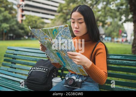 Asian woman looking at a map. Stock Photo