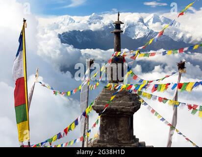 view from Langtang to Ganesh Himal with stupa and prayer flags and beautiful clouds - Nepal Stock Photo