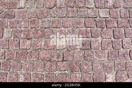 Old cobblestone pavement close-up. Pavement texture. Stock Photo