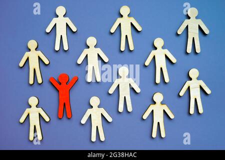 Be different concept. One unique figurine in the crowd as symbol of uniqueness. Stock Photo