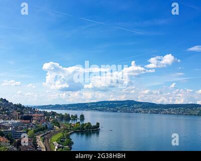 Idyllic Swiss landscape, view of lake Zurich in Richterswil, Switzerland, mountains, blue water of Zurichsee, sky as summer nature and travel Stock Photo