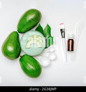 Skin care beauty product natural organic cosmetics made from avocado oil, essential oil on White background square. Avocado Body Scrub or face mask Stock Photo