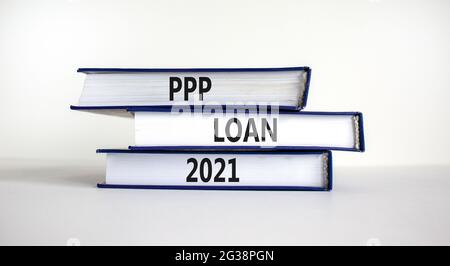 PPP, paycheck protection program loan 2021 symbol. Concept words PPP loan 2021 on books on a beautiful white background. Business, PPP - paycheck prot Stock Photo