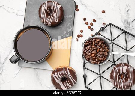 Composition with cup of coffee and donuts on marble background Stock Photo