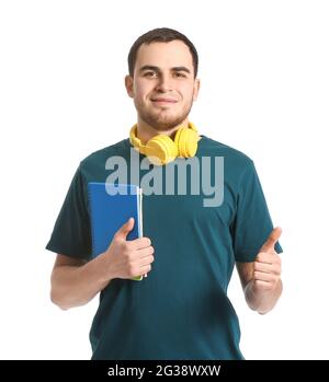 Young man with headphones showing thumb-up on white background Stock Photo