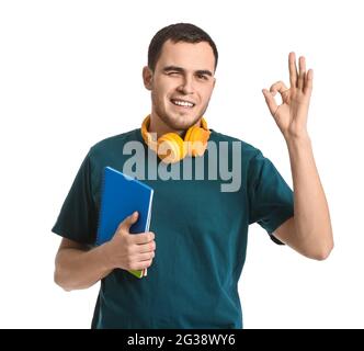 Young man with headphones showing OK on white background Stock Photo