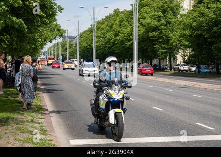 Police officer with motorcycle clearing the way for Helsinki City Rescue Department 160th anniversary parade in Munkkiniemi, Helsinki, FInland Stock Photo