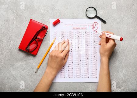 Student passing school test on grey background Stock Photo