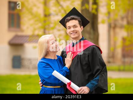 Happy young man with his mother on graduation day Stock Photo