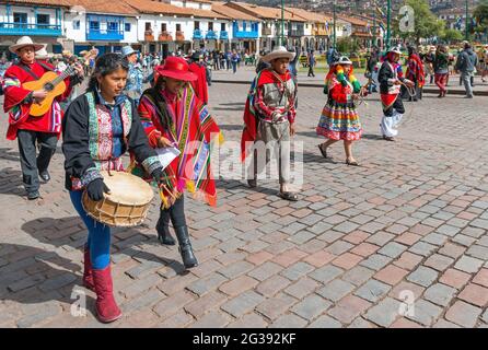 Peruvian people walking in traditional clothing during Inti Raymi sun festival celebrations with music instruments, Cusco, Peru. Stock Photo