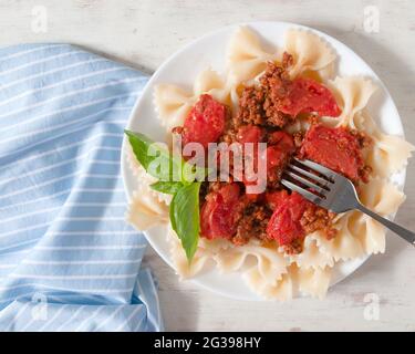 Delicious farfalle with bolognese sauce. An Italian hot dish. Stock Photo