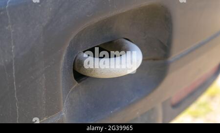 Towbar loop. Attach the vehicle to the front of the vehicle. White steel part in the bumper. Close-up. Car towing hitch. Vehicle hitch type Stock Photo