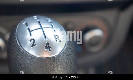 Knob for selecting the gear of a manual gearbox. Manual transmission knob in the car. Close-up of the gear shift lever. Vehicle interior. Detail of th Stock Photo