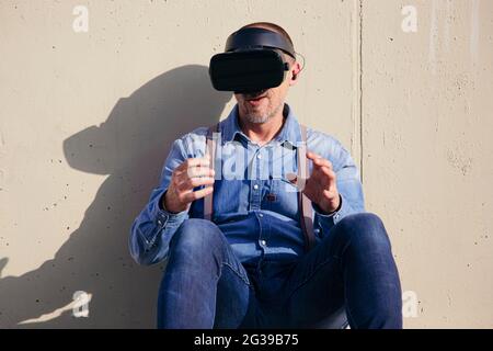 Happy man wearing VR glasses Stock Photo