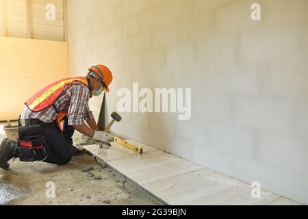 Laying Ceramic Tiles.Home tile improvement Stock Photo