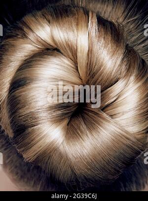 Close up topknotBeautiful fashionable hairstyle. Pretty woman back and head on white background Stock Photo