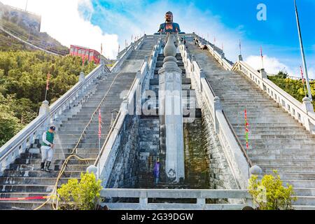 The steep steps leading to the large buddah on top of Fansipan mountain, Sapa, in the Lao Cai provice of Vietnam on a cloudy day Stock Photo
