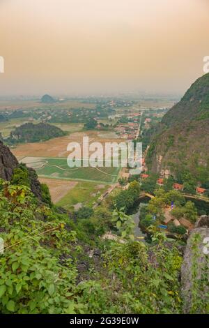 A view of the saturated landscape and houses near Mua Cave in the Ninh Binh province of Vietnam Stock Photo