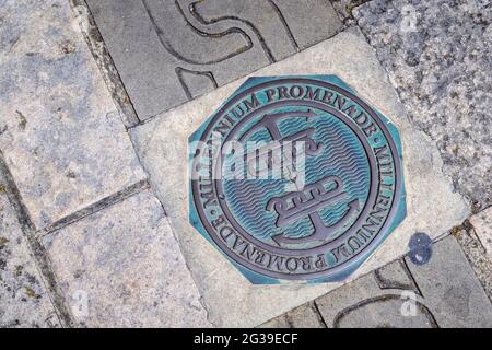 Marker for the coastal Millennium Promenade walk on the seafront in the pavement in Old Portsmouth, Hampshire, south coast England Stock Photo