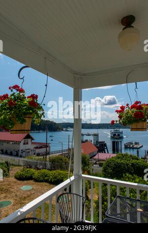 View of the Orcas Island Ferry Landing with an approaching ferry from the Orcas Hotel, a historic inn and cafe built 1904, in Orcas Village on Orcas I Stock Photo