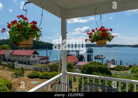 View of the Orcas Island Ferry Landing with an approaching ferry from the Orcas Hotel, a historic inn and cafe built 1904, in Orcas Village on Orcas I Stock Photo