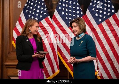 Representative Melanie Stansbury (D-NM) and Speaker of the House Nancy Pelosi (D-CA) during the ceremonial swearing-in for Rep. Stansbury, at the U.S. Capitol, in Washington, DC, on Monday, June 14, 2021. After a weekend dominated by news of President Biden's first trip abroad to attend the G-7 and NATO summits, Congress returns to negotiations over infrastructure that have dragged on for weeks with little tangible progress, and explosives revelations about Department of Justice investigations into Congresspeople and journalists.(Graeme Sloan/Sipa USA) Stock Photo