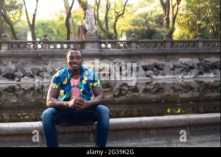 Young handsome smiling ?exican male in a park Stock Photo