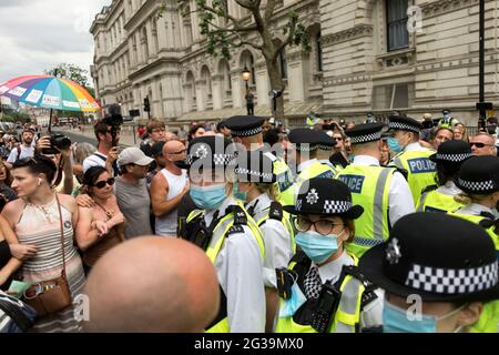 London, UK. 15th June, 2021. Police officers confront protestors outside Downing street during the demonstration.UK Prime Minister Boris Johnson is due to make an announcement regarding the extension of the lockdown regulations in the UK. Protestors gathered outside Downing Street at 12pm to protest against the extension, on the grounds that it is a violation of human rights and various freedoms. They also protested against wearing masks and being subjected to the vaccination program. (Photo by Belinda Jiao/SOPA Images/Sipa USA) Credit: Sipa USA/Alamy Live News Stock Photo