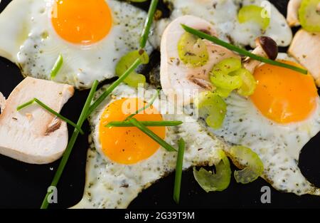 Fried quail eggs with champignons Stock Photo