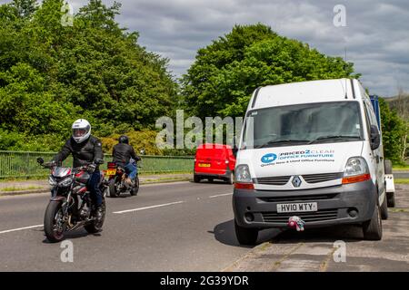 Commercial vehicles & trailer Advertising by parking on pavement across Motorway bridge restricting busy traffic access in Chorley, UK Highway Code rule 242 states: 'You must not leave your vehicle or trailer in a dangerous position or where it causes any unnecessary obstruction of the road Stock Photo