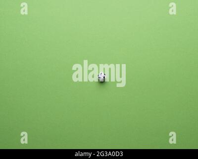 Soccer field, view from above, crumpled paper ball as a soccer ball on a green paer background as lawn Stock Photo