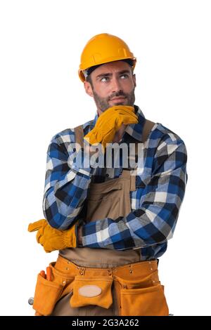 Portrait of contractor worker in coveralls and hardhat holding chin isolated on white background Stock Photo