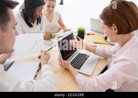 Diverse executive business people team discussing work results at meeting, multiracial businessmen talking analyzing financial statistics report sitti Stock Photo