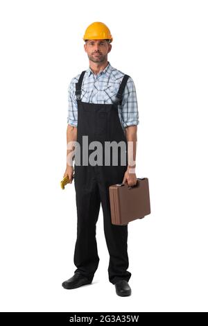 Full length portrait of confident male repairman contractor worker in coveralls holding adjustable spanner and toolbox on white background Stock Photo