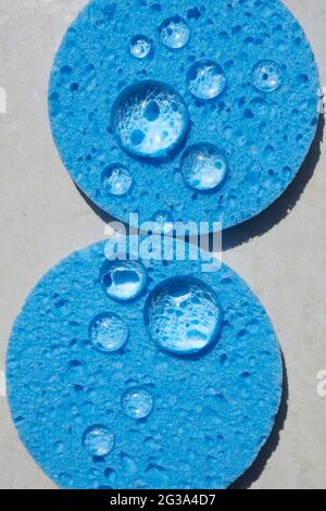 Blue sponge close up with water drops. Face Cleansing and Make Up Removing Beauty Routine Stock Photo