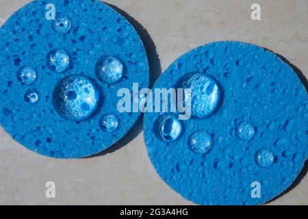 Blue sponge close up with water drops. Face Cleansing and Make Up Removing Beauty Routine Stock Photo