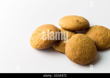 Gingerbread round cookies in a heap isolated on white background with copy space - gingersnap biscuits background Stock Photo