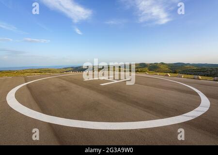 Empty helipad on top of a peak in a country side remote location Stock Photo