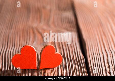 Two red handmade wooden carved hearts on wood background couple relationship Valentine day concept Stock Photo