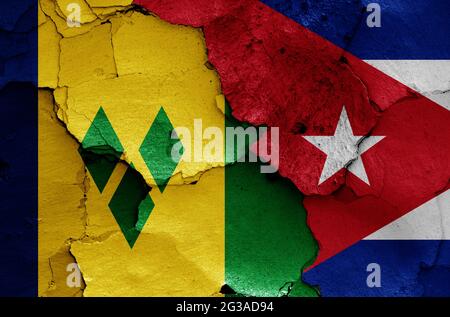 flags of St Vincent and the Grenadines and Cuba painted on cracked wall Stock Photo