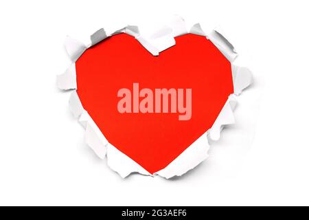 Close up of a ripped paper hole red heart shaped on white background copy space Stock Photo