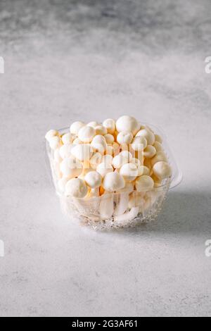 White Asian Enoki mushroom, raw vegan food, fungus, close-up Stock Photo