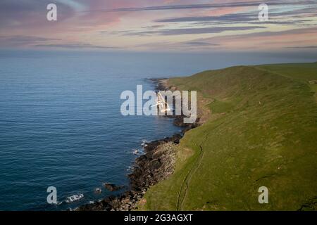 An abandoned ship washed onto rocks near Ballycotton in east Cork after storm Dennis hit Ireland Stock Photo