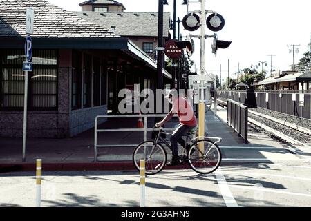 San Mateo, USA. 14th June, 2021. A man rides on the street in San Mateo, California, the United States, June 14, 2021. California Governor Gavin Newsom and government health officials announced the official reopening of the state from Tuesday following months of anticipation.The reopening means that vaccinated people in California can go maskless in public, there will be no more limitations on out-of-state travelers, and California retail businesses can go back to full capacity. Credit: Wu Xiaoling/Xinhua/Alamy Live News Stock Photo